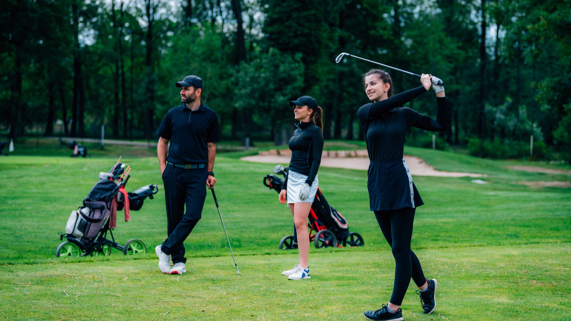 two girls learning to play golf